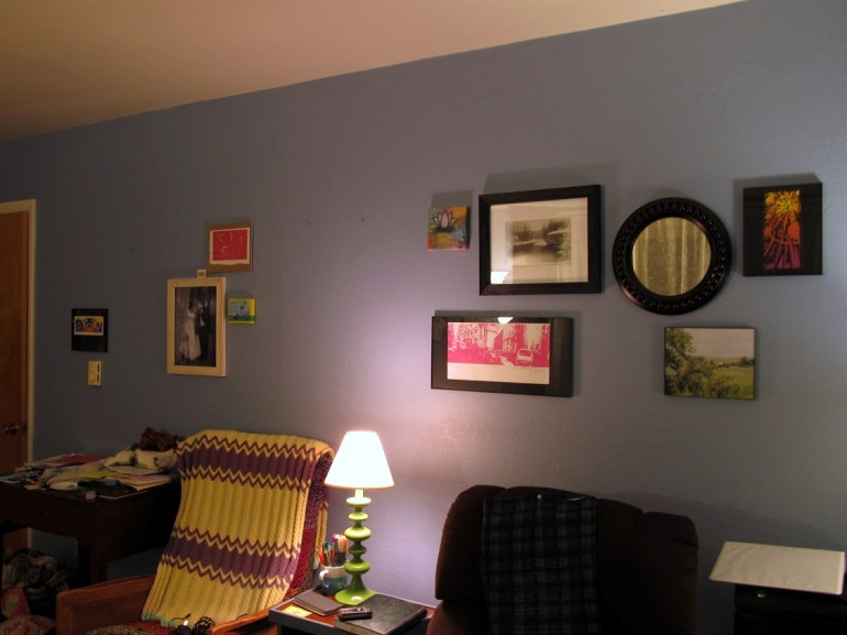 Our living room wall. Notice anything off? i mean besides the piles on my sewing machine.