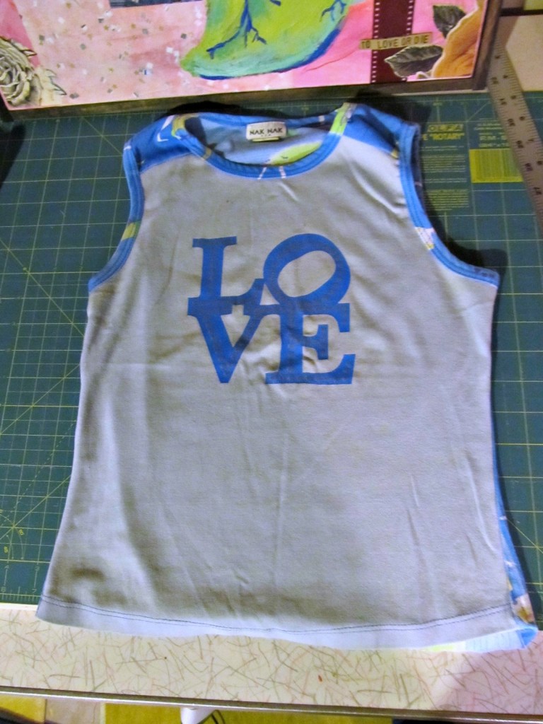 This shirt was the starting point for all pages. After digging through my stash, I knew I wanted each page to have three different fabrics. I also wanted this whole "love" block to be visible. So I cut it out, added the other blues and based all pages sizes off that.