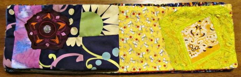 Purple page: Mostly from a purse I loved to literal pieces. Also has a strip of fabric I painted and a medallion from a tank I wore in high school.  Yellow page: Two yellow stash cottons and lace from a shelled cami.