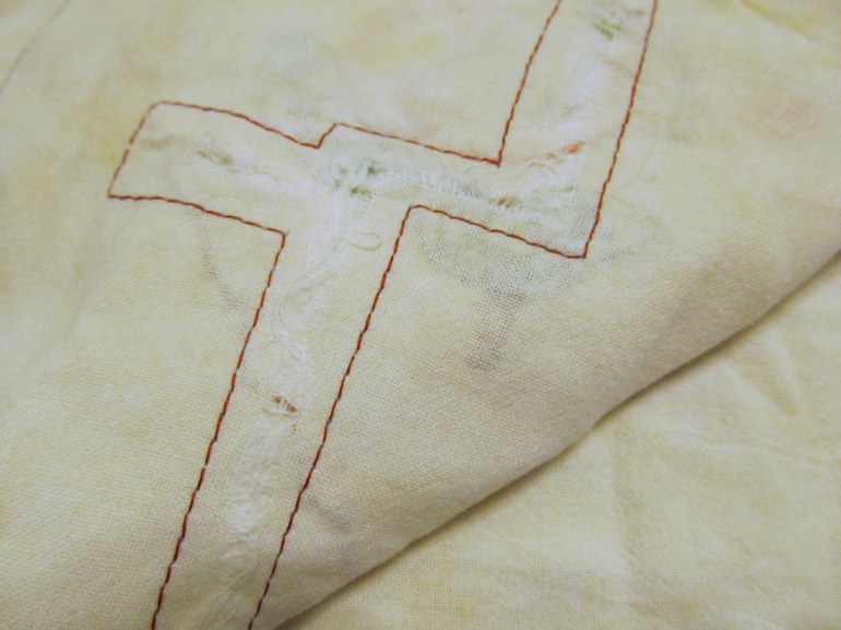 That huge rip actually looks kind of cool with bright red thread.